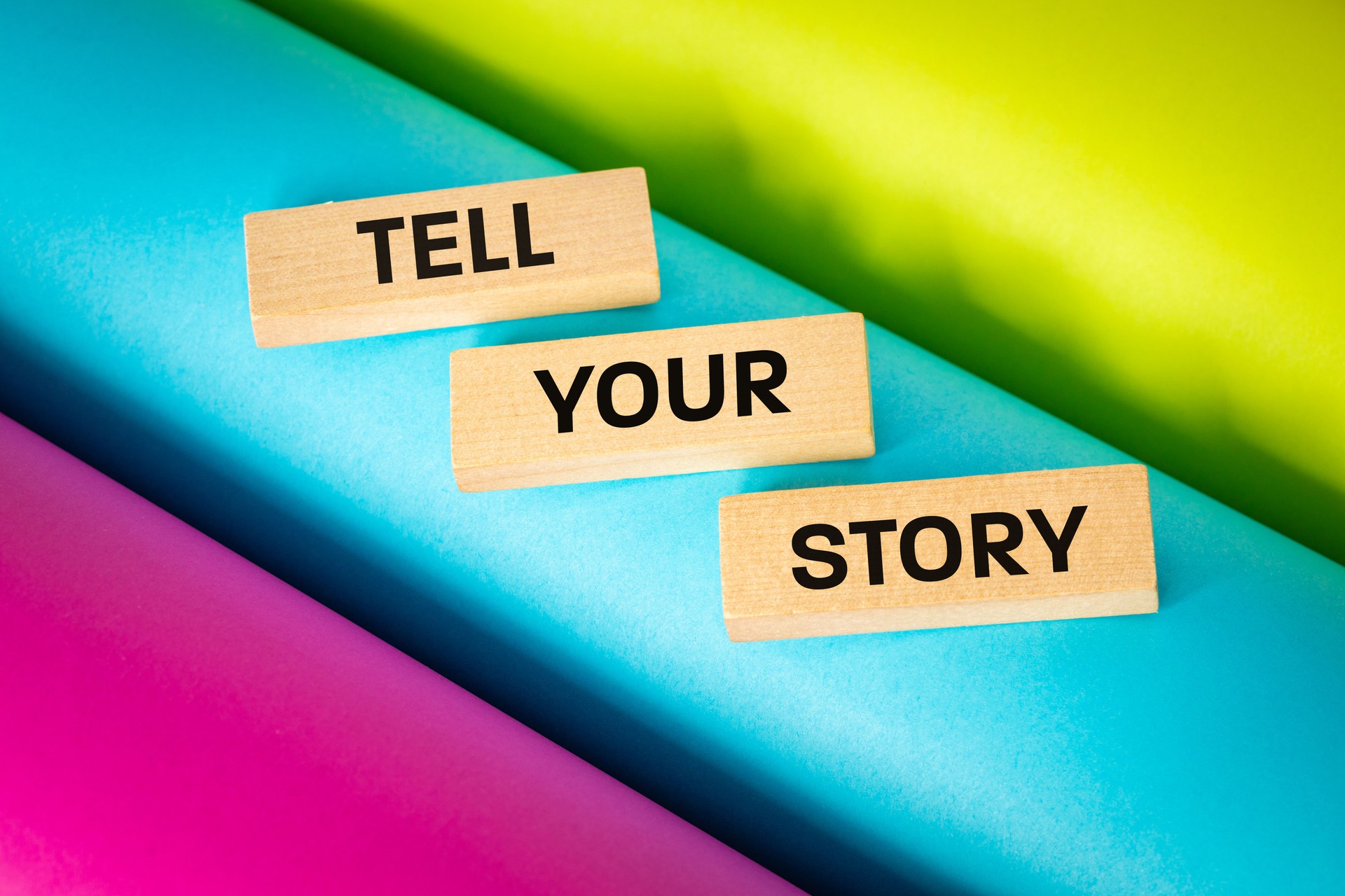Tell Your story symbol, Wooden blocks with words Tell Your Story. Beautiful multicolored background. business and social concept and tell your story, Copy space